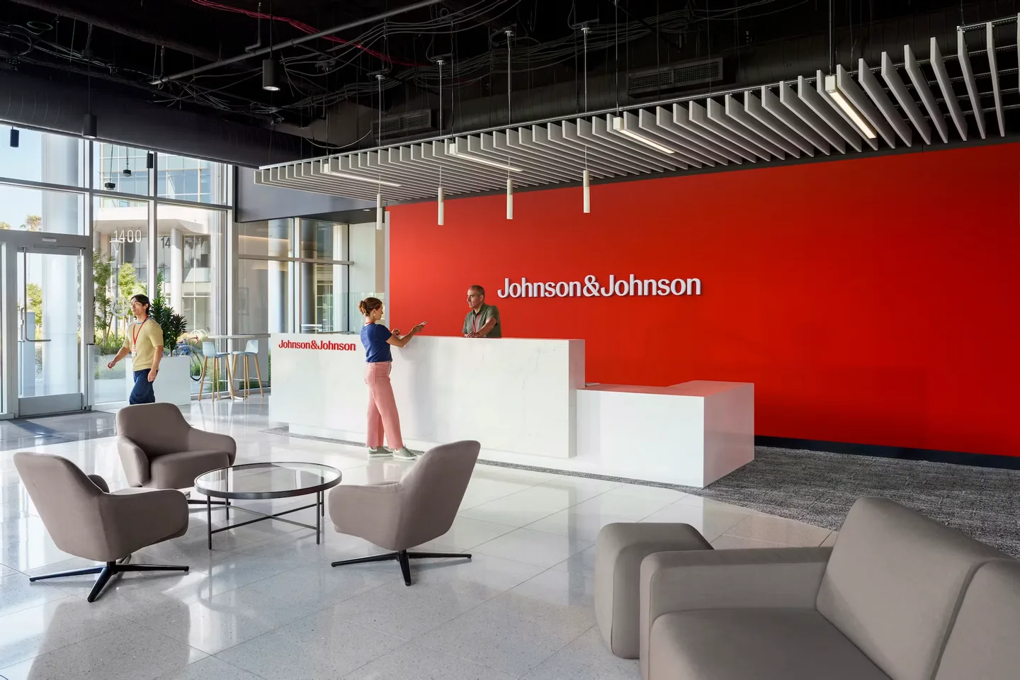 Johnson & Johnson reception space with a red feature wall