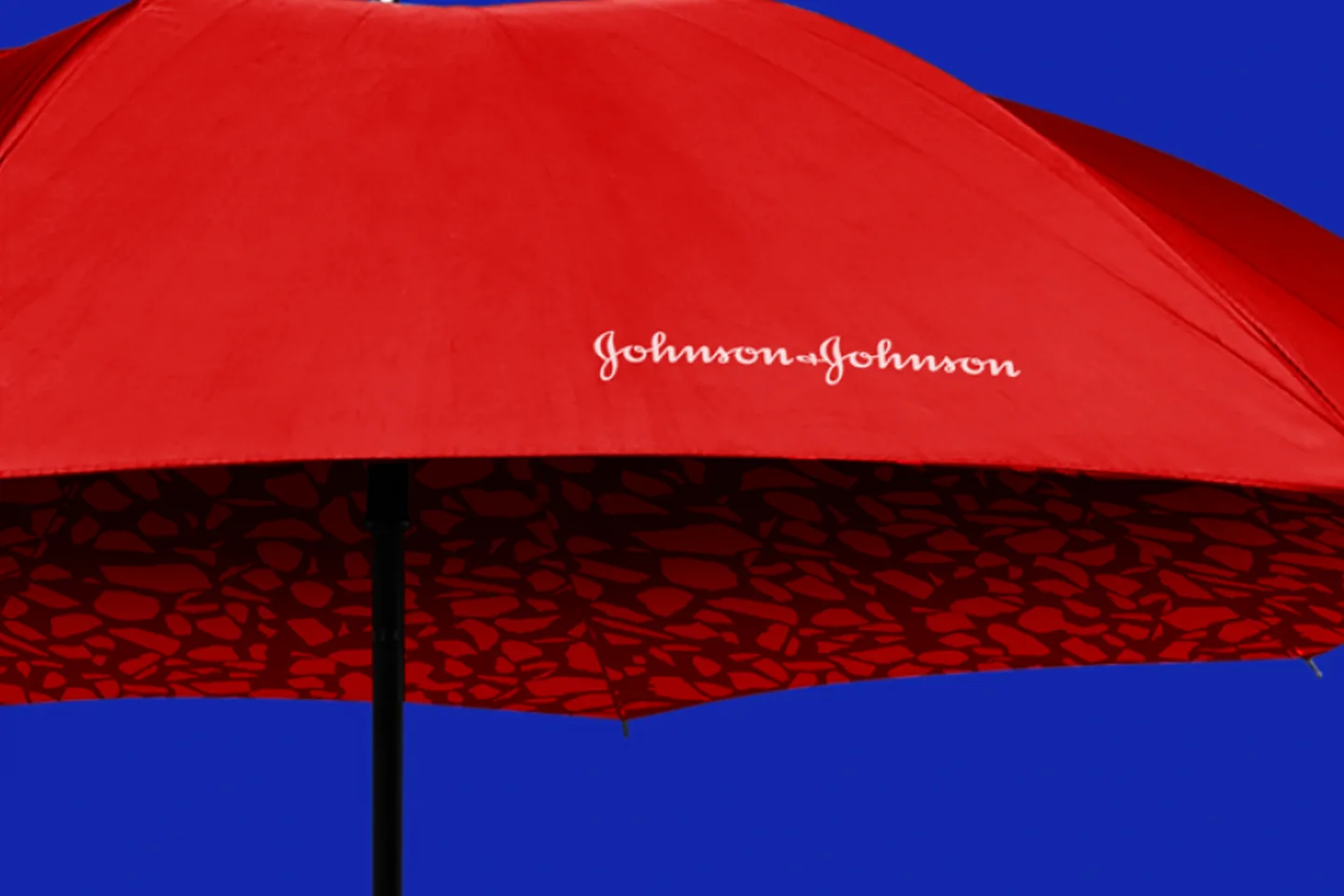Red Johnson & Johnson umbrella against a blue background
