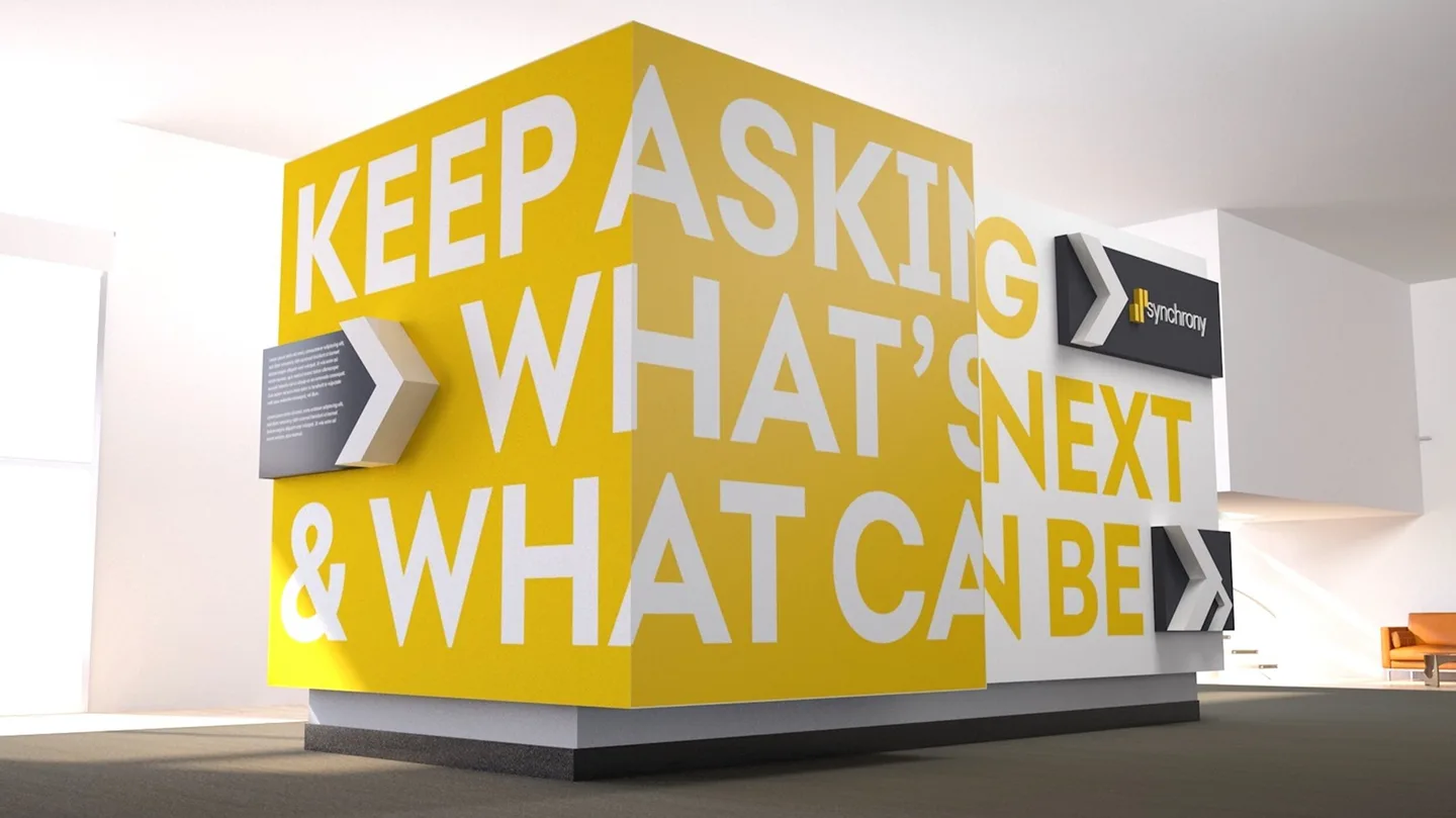 Synchrony headquarters environment with oversized white typography wrapping around a yellow corner