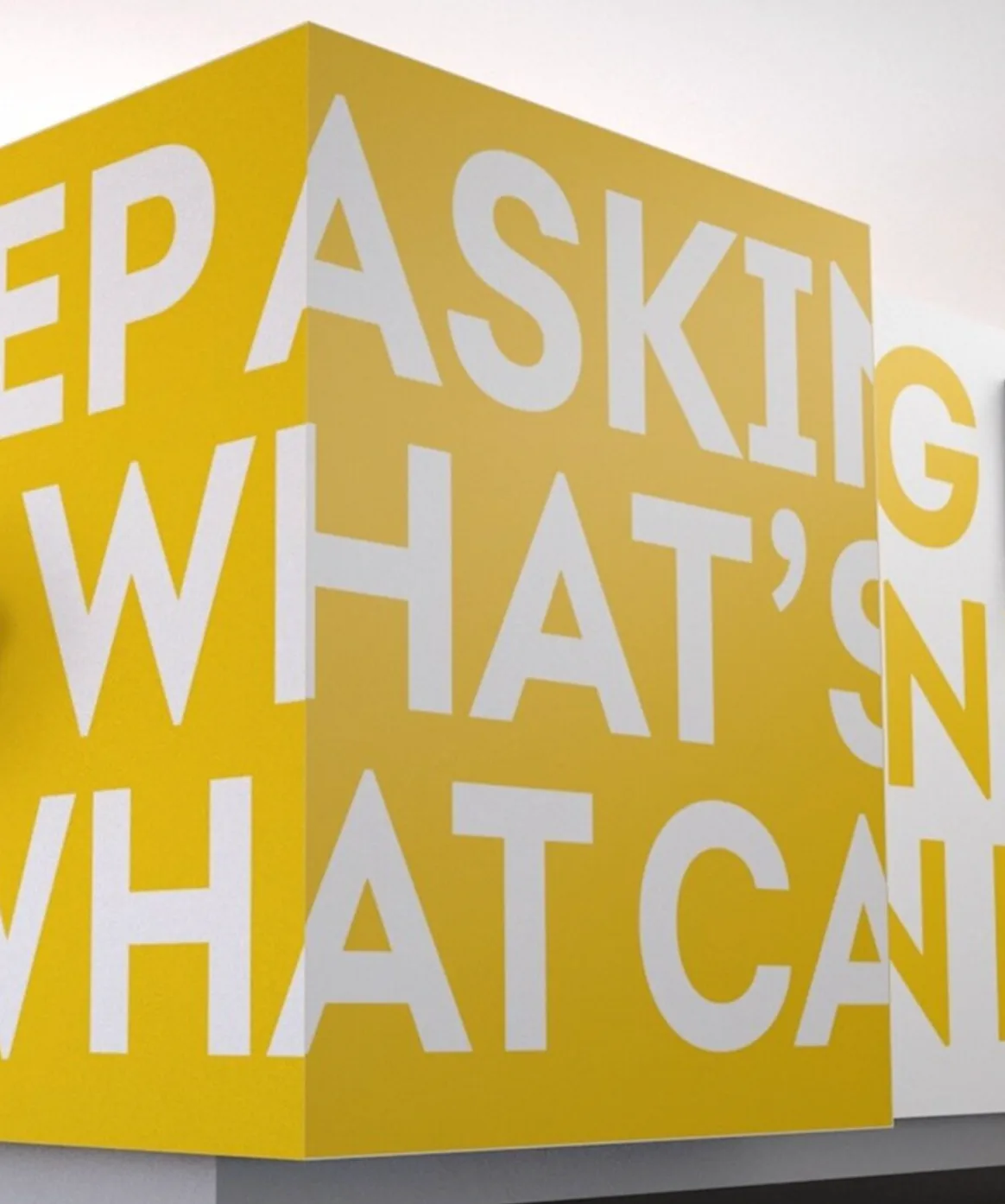 Oversized white typography wrapping around a yellow corner in Synchrony’s headquarters
