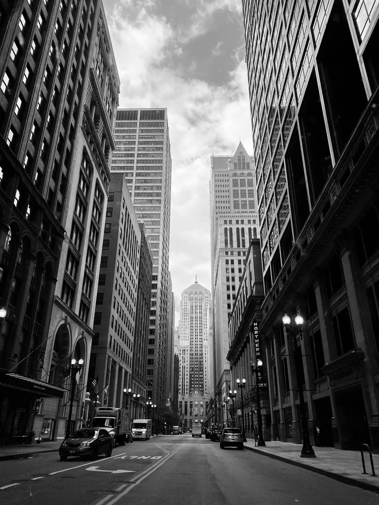 Downtown towers rising along an empty street