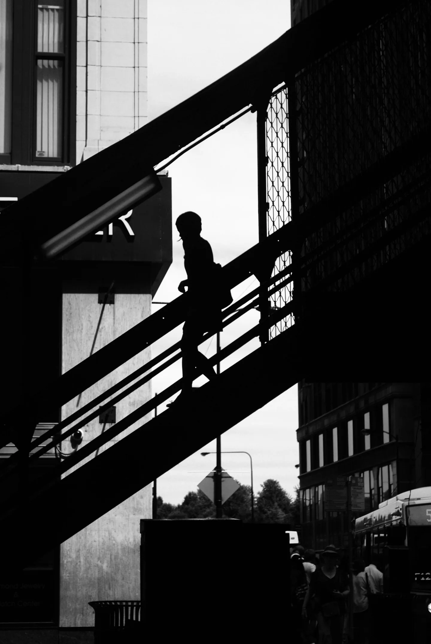 Silhouetted figure climbing an outdoor staircase