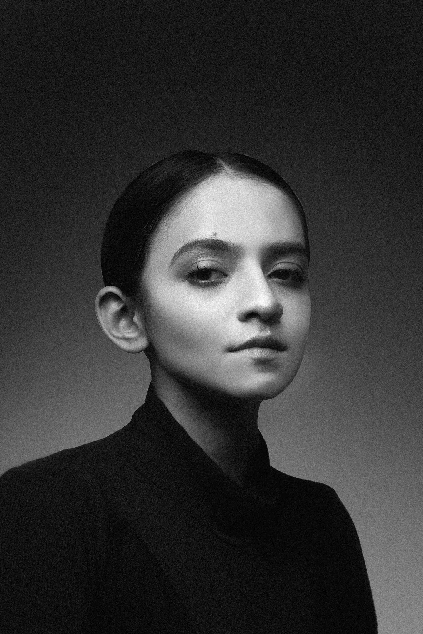 Studio portrait of a woman in a dark turtleneck