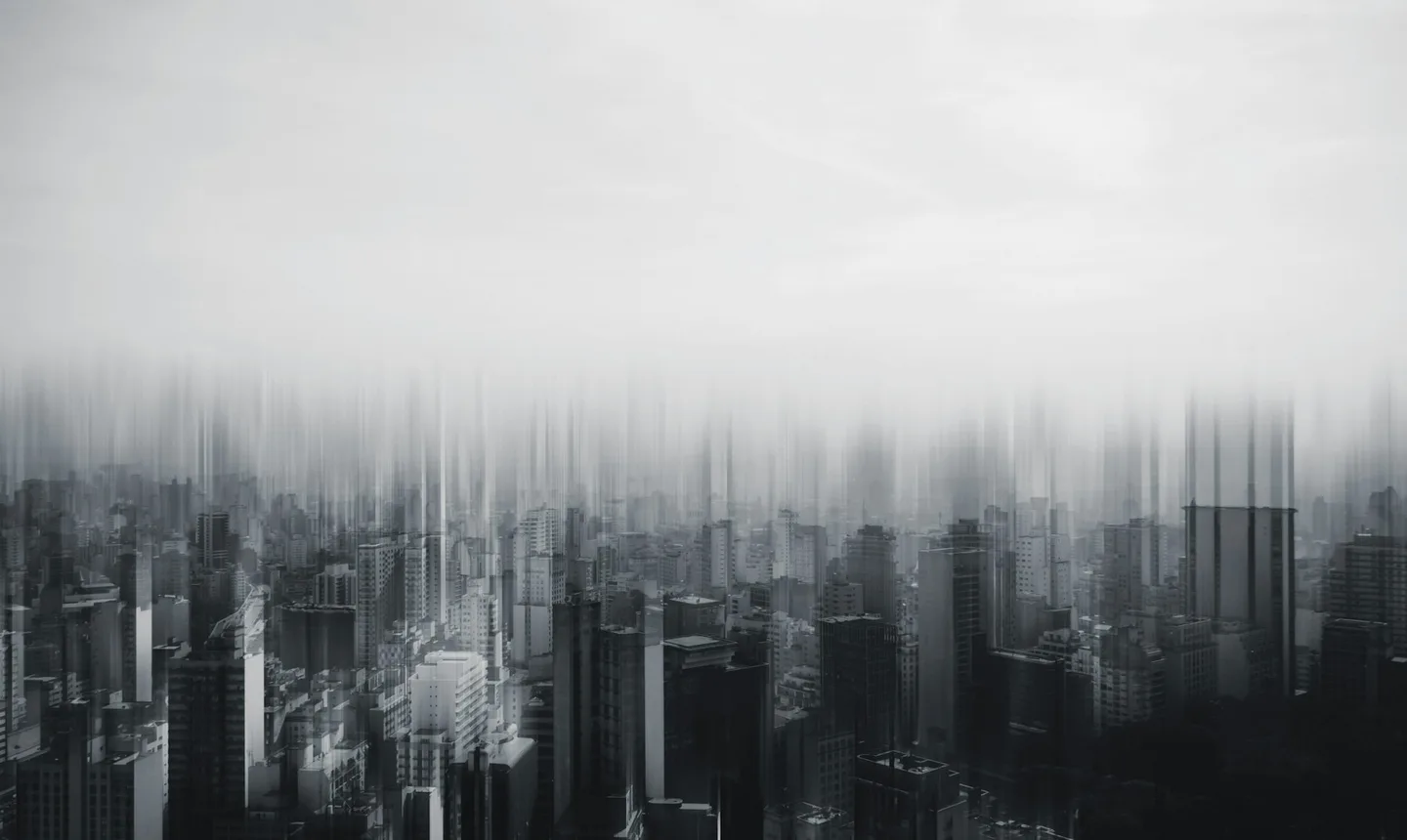 City skyline dissolving vertically into mist