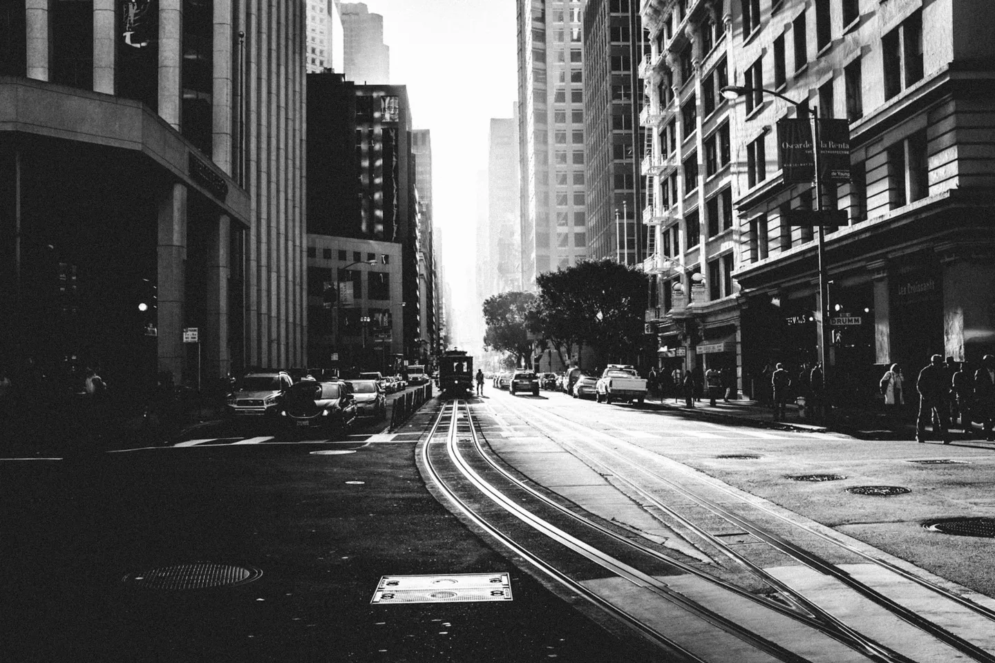 Cable-car tracks receding through a sunlit city street